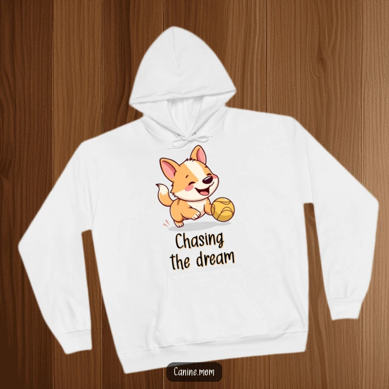 Funny dog hoodie featuring a joyful dog with a wagging tail, intensely focused on a bouncing ball, embodying pure canine happiness.